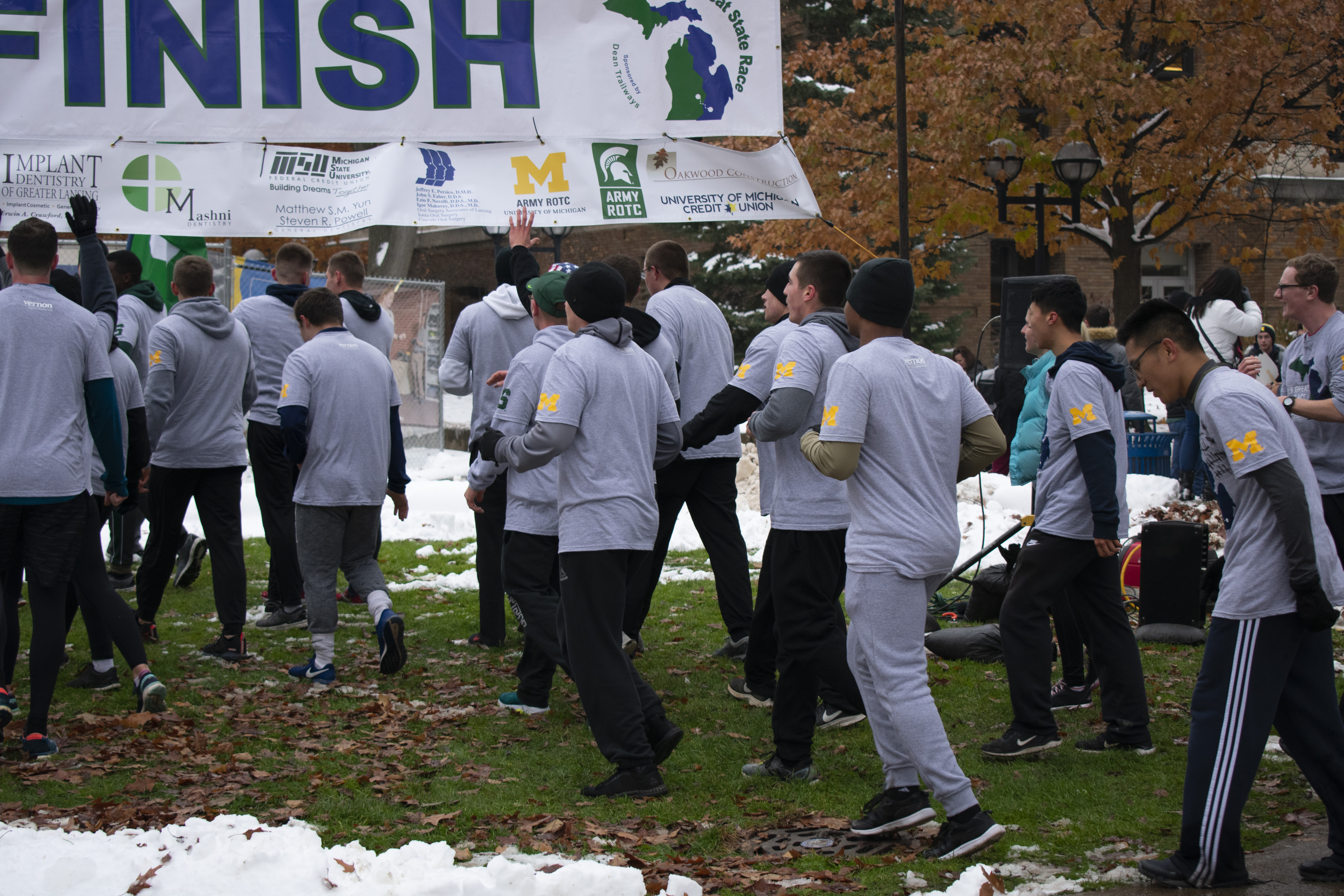 ROTC from U of M and MSU running under the finish line